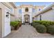 Inviting front entrance with a brick pathway, well-manicured shrubs, and an arched entryway at 4929 Tennessee Lake Dr, Auburndale, FL 33823