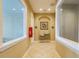 Well-lit hallway with tile flooring, water fountains, artwork, and access to restrooms at 4929 Tennessee Lake Dr, Auburndale, FL 33823