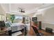 Cozy main bedroom with hardwood floors, a tray ceiling, and views of the outside from the large window at 4929 Tennessee Lake Dr, Auburndale, FL 33823