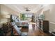 Bright main bedroom featuring hardwood floors, a tray ceiling, and a view of the surrounding landscape at 4929 Tennessee Lake Dr, Auburndale, FL 33823