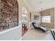 Relaxing sitting area with a stone accent wall, tile flooring, and comfortable chaise lounge at 4929 Tennessee Lake Dr, Auburndale, FL 33823