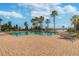 Serene community pool with lounge chairs and mature palms trees, perfect for relaxation at 4929 Tennessee Lake Dr, Auburndale, FL 33823