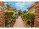 Brick walkway leading to the entrance, surrounded by lush greenery and vibrant plants, creating a welcoming ambiance at 4929 Tennessee Lake Dr, Auburndale, FL 33823