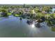 Breathtaking aerial view of waterfront homes on a serene lake, reflecting sunlight and surrounded by lush greenery at 502 Lake Harris Dr, Lakeland, FL 33813