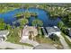 Stunning aerial view of a well-maintained home with a manicured lawn, situated by a beautiful lake at 502 Lake Harris Dr, Lakeland, FL 33813