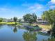 Back of home along lake offers a screened enclosure, boat dock, and mature landscaping at 502 Lake Harris Dr, Lakeland, FL 33813