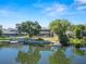 Back of home along lake offers a screened enclosure, boat dock, and mature landscaping at 502 Lake Harris Dr, Lakeland, FL 33813