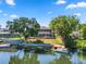 Large lakefront home with a backyard featuring a pool, boat dock and mature landscaping at 502 Lake Harris Dr, Lakeland, FL 33813