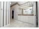 Bathroom with double vanity, large mirrors, and classic striped wallpaper at 502 Lake Harris Dr, Lakeland, FL 33813