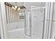 Bathroom featuring a corner tub and glass-enclosed shower with brass hardware at 502 Lake Harris Dr, Lakeland, FL 33813