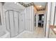 Bathroom featuring a corner tub and glass-enclosed shower at 502 Lake Harris Dr, Lakeland, FL 33813