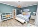 Comfortable bedroom featuring three windows, accent furniture, and wood-look tile floors at 502 Lake Harris Dr, Lakeland, FL 33813