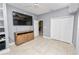 Neutral toned bedroom features tile flooring, ceiling fan, entertainment center, and a spacious closet at 502 Lake Harris Dr, Lakeland, FL 33813