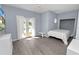 Well-lit bedroom featuring a built-in bed, wood floors, and a sliding glass door at 502 Lake Harris Dr, Lakeland, FL 33813