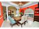 Open dining room with decorative chandelier and colorful accent wall at 502 Lake Harris Dr, Lakeland, FL 33813