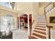 Bright foyer with soaring ceilings and elegant staircase at 502 Lake Harris Dr, Lakeland, FL 33813