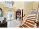 Inviting home foyer with beautiful tile floor and staircase at 502 Lake Harris Dr, Lakeland, FL 33813