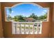 Exterior view of the house through a decorative arch with view of front yard at 502 Lake Harris Dr, Lakeland, FL 33813