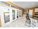 Kitchen nook featuring bar seating and access to the outdoor pool area through large glass doors at 502 Lake Harris Dr, Lakeland, FL 33813