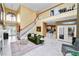 Spacious living room with staircase, tile flooring, and view to the kitchen at 502 Lake Harris Dr, Lakeland, FL 33813