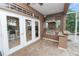 Covered outdoor kitchen with a stainless steel grill, granite countertops, and bar seating at 502 Lake Harris Dr, Lakeland, FL 33813