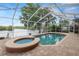 Screened-in pool and spa with an interlock patio and scenic views of the beautiful waterfront at 502 Lake Harris Dr, Lakeland, FL 33813