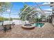 Enclosed pool and hot tub overlooking the water, perfect for relaxation and entertaining at 502 Lake Harris Dr, Lakeland, FL 33813