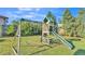 Backyard view of a wooden playset with swings and a slide, perfect for Gathering fun and outdoor activities at 5207 St Lucia Dr, Lakeland, FL 33812