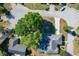 Aerial view showcases the property's location in a serene residential neighborhood with tree-lined streets at 5730 Tanasi Ct, Lakeland, FL 33812