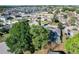 An aerial view of a home with a screened-in pool surrounded by mature trees in a quiet neighborhood at 5730 Tanasi Ct, Lakeland, FL 33812