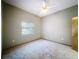 Bedroom featuring neutral carpet, gray walls, and a large window with blinds at 5730 Tanasi Ct, Lakeland, FL 33812