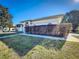 Side view of a single-story home with a well-manicured lawn and mature landscaping at 5730 Tanasi Ct, Lakeland, FL 33812