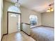 Inviting foyer with neutral tile flooring, an arched transom window, and entry into a spacious living area at 5730 Tanasi Ct, Lakeland, FL 33812