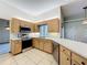 Kitchen area with stainless steel appliances, tiled floor and window above sink at 5730 Tanasi Ct, Lakeland, FL 33812