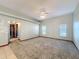 Spacious living room with carpet flooring, ceiling fan, and natural light from windows at 5730 Tanasi Ct, Lakeland, FL 33812