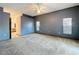 Large main bedroom featuring neutral carpet, ceiling fan, and ensuite bathroom at 5730 Tanasi Ct, Lakeland, FL 33812