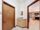 Entryway with a utility sink, storage cabinet and doorway leading to the kitchen at 5730 Tanasi Ct, Lakeland, FL 33812