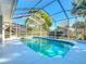 Sparkling screened-in pool with ample deck space and clear blue water at 5730 Tanasi Ct, Lakeland, FL 33812