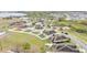 Aerial view of the neighborhood, featuring well-maintained homes, green spaces, and a picturesque lake in the background at 5798 Dornich Dr, Auburndale, FL 33823