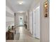 Bright hallway with decorative white and beige stripes leads to the front door at 5798 Dornich Dr, Auburndale, FL 33823