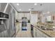 Kitchen featuring stainless steel appliances, granite countertops, and breakfast bar seating at 5798 Dornich Dr, Auburndale, FL 33823