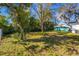 A large backyard with mature trees and an outbuilding at 604 W 10Th St, Lakeland, FL 33805