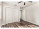 Bright bedroom featuring new flooring, a ceiling fan, and a large closet at 604 W 10Th St, Lakeland, FL 33805