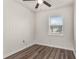 Cozy bedroom with a ceiling fan, wood-look floors, and natural light from the window at 604 W 10Th St, Lakeland, FL 33805