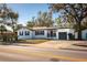 Charming single-story home with a white exterior, dark shutters, and a well-maintained front yard at 604 W 10Th St, Lakeland, FL 33805