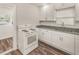 Kitchen featuring white cabinetry, granite counters, and modern appliances at 604 W 10Th St, Lakeland, FL 33805