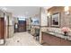 Comfortable bathroom featuring a vanity with decorative tiling, granite countertop, lockers, and tile flooring at 6211 Crane Dr, Lakeland, FL 33809