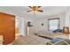 Shared bedroom featuring two beds, a ceiling fan, and a view of the en-suite bathroom at 6211 Crane Dr, Lakeland, FL 33809