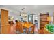 Dining area featuring hardwood floors, a wooden table with six chairs, and a built-in bookshelf at 6211 Crane Dr, Lakeland, FL 33809