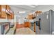 Bright kitchen featuring granite countertops, wood cabinetry, and stainless appliances at 6211 Crane Dr, Lakeland, FL 33809